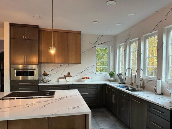 modern kitchen with calacatta quartz countertops full height backsplash and wood cabinetry in contemporary home interior