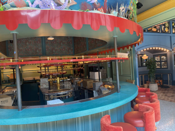 custom curved restaurant bar counter with colorful stone surface and decorative interior design