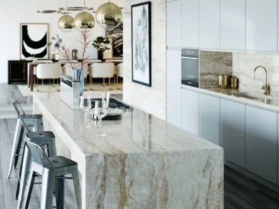modern kitchen with large marble waterfall island contemporary cabinets gold pendant lights and bar seating