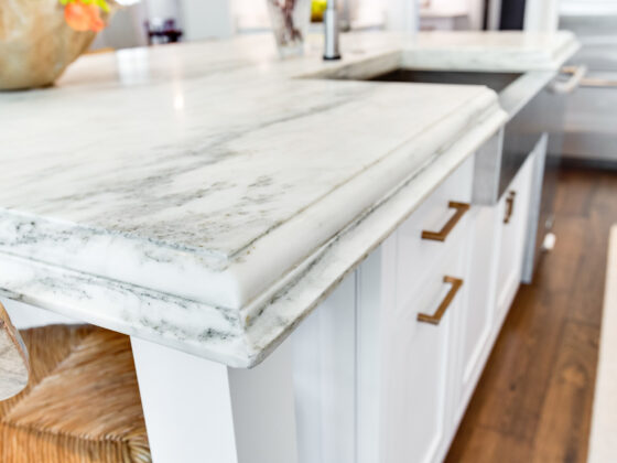 white marble kitchen countertop with beveled edge detail modern cabinetry and undermount sink
