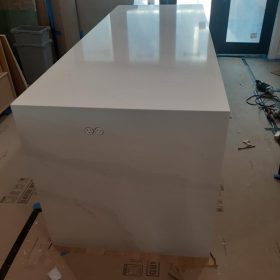 custom white quartz waterfall island countertop under installation in modern kitchen interior