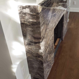 modern fireplace with dramatic marble stone surround and floor to ceiling stone cladding