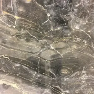 Arabescato Orobico marble slab with dramatic gray and brown veining on a light background for luxury countertops and interior stone surfaces