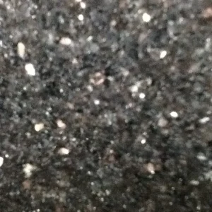 Black Galaxy granite slab with deep black background and sparkling gold mineral flecks ideal for luxury kitchen countertops and interior stone surfaces