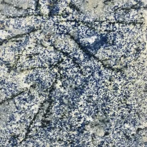 Blue Bahia granite slab with vibrant deep blue background and natural mineral patterns ideal for luxury kitchen countertops and statement interior surfaces