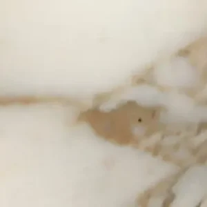 Calacatta Gold marble slab with white background and elegant gold and gray veining ideal for luxury kitchen countertops and interior stone surfaces