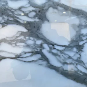 Calacatta Carrara marble slab with white background and elegant gray veining suitable for luxury countertops, backsplashes, and interior stone surfaces