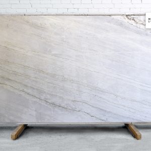 Calacatta Quartzite Polished natural stone surface with bright white background and bold grey veining for luxury kitchen and bathroom countertops