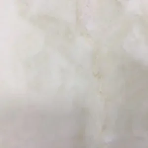 Dolce Vita natural stone slab with warm beige tones and soft flowing veining for luxury countertops and interior surfaces