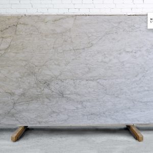 Gabana Polished natural stone surface with warm beige and grey tones and subtle flowing veining for elegant kitchen and bathroom countertops
