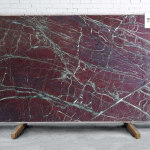 Moulin Rouge Polished natural stone surface with deep red tones and dramatic natural veining for luxury countertops and statement surfaces