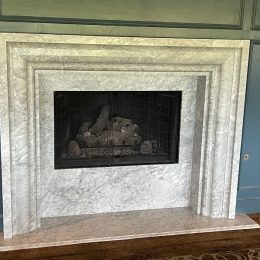 elegant marble fireplace surround with layered stone mantel design and built-in gas fireplace
