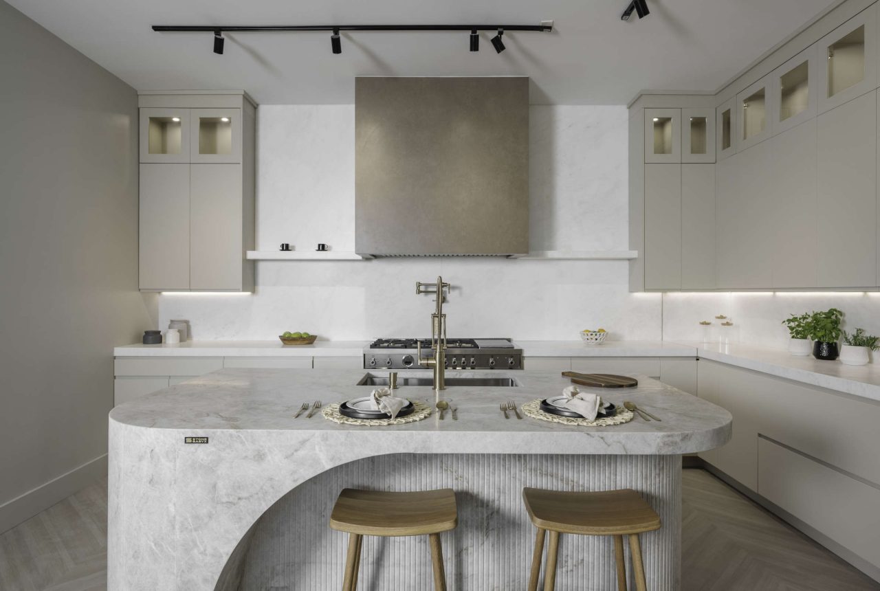 Modern luxury kitchen interior with marble island countertop, built-in sink, and minimalist cabinetry design